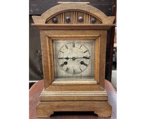 A Junghans walnut cased mantle clock, with a silvered dial and Roman numerals, striking on a gong