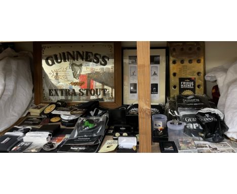 Guinness memorabilia including shirts, slippers, Zippo lighter, advertising mirror, cufflinks, pin badges, pens, wallet, mats