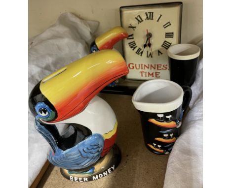 A Guinness Toucan Clock, G0051 together with a Heritage Toucan Money Box, G0052 and a Toucan Ceramic Creamer G0079a