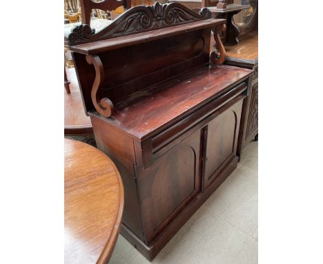 A Victorian mahogany chiffonier, with a shelf, a frieze drawer and a pair of cupboards on a plinth base   