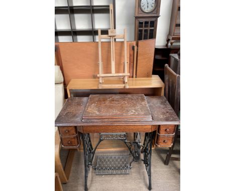 A Singer sewing machine table with cast iron base together with a bookcase and a table top easel