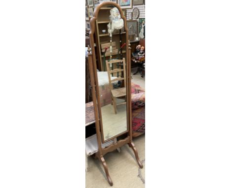 A walnut framed cheval mirror with an arched top on shaped legs