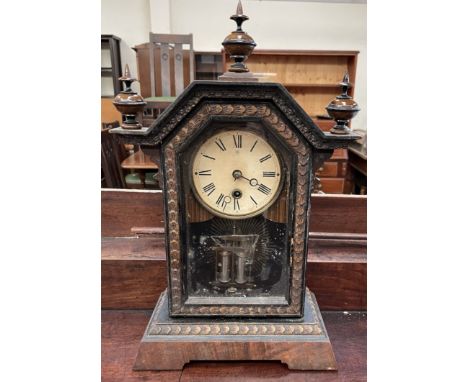 A Junghans mantle clock, with turned finials on bracket feet