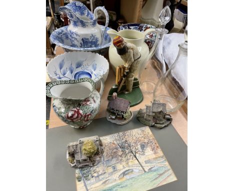 A blue and white jug and basin set together with pottery jugs, bowls, Lilliput lane cottages, W.G Grace door stop, decanters 