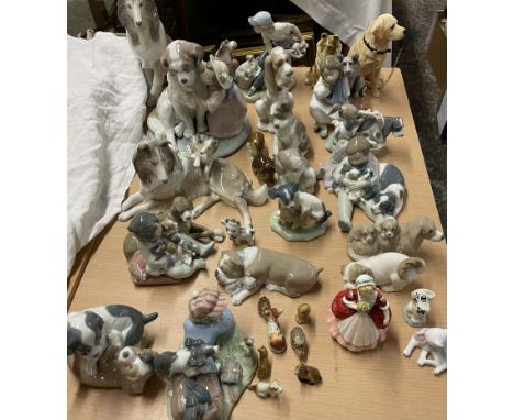 A collection of Lladro and Nao dog figures and figure groups together with a Royal Doulton figure, wade etc