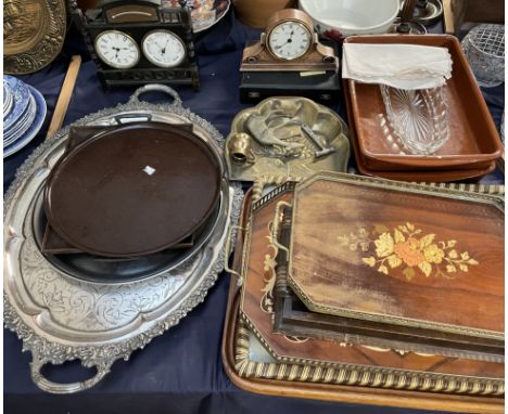An ebonised clock and barometer together with another clock, trays etc