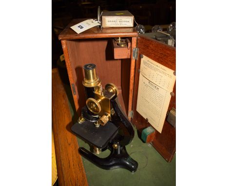 An early 20th Century monocular microscope inscribed 'Charles Perry, 41 Northholme Road, London, No. 5514', in fitted case, o