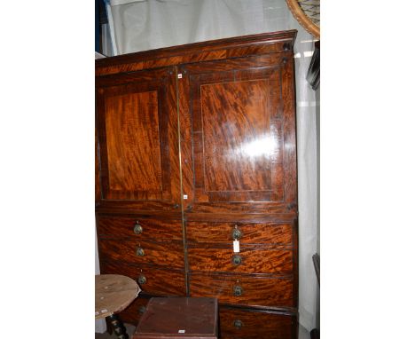 *A converted George III mahogany wardrobe, the flared cornice above cupboard doors with crossbanded and inlaid panels above d