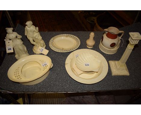 *A collection of 19th Century creamware, to include: a pair of figures; a candlestick; a shell-shaped dish; dishes; together 