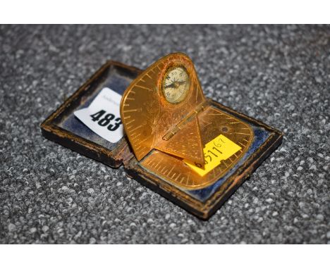 *A 19th Century giltmetal travelling sun dial and compass, inscribed 'Patent 1875 Birmingham' in fitted leather case.