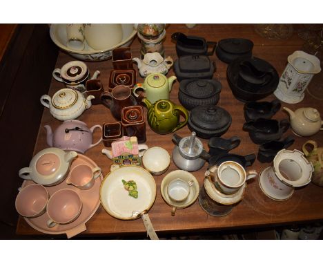 *A quantity of basalt ware tea items, including: sugar bowls; cream jugs; a Poole part bachelors tea service; and other tea w