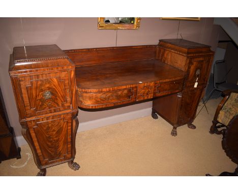 *A Regency mahogany sideboard, in the Scottish taste, the bowfront sunken central top fitted two frieze drawers, flanked by p