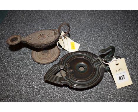 *An Egyptian style bronze oil lamp with snake handle, by B. & A.B; together with a cast iron oil lamp with floral decoration.