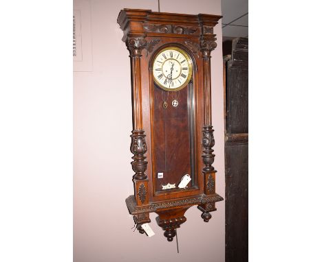 A Venetian style wall clock, the roman enamelled dial within case decorated with columns and leaves.