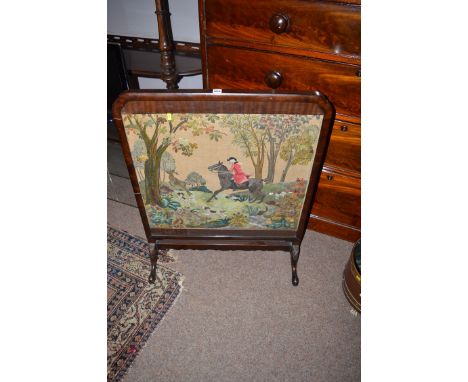 A fireguard with needlework hunting scene.