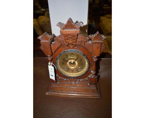 A 19th Century chiming mantel clock in ornate oak case.