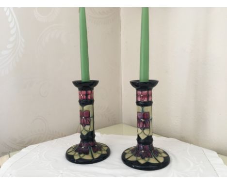 A stunning pair of Moorcroft candlesticks featuring the brand's signature design and vibrant glazes. Standing at 21 cm in hei