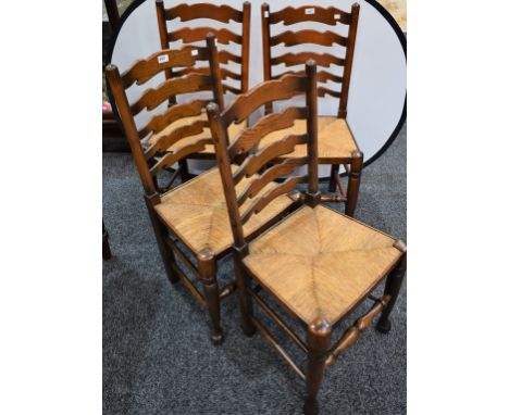 A set of four oak ladder back rush seated dining chairs (4)