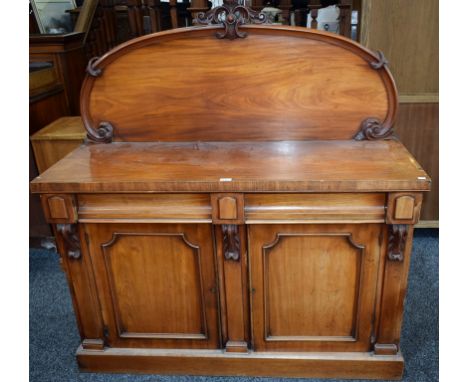 A Victorian mahogany sideboard, shaped half gallery above a pair of frieze drawers and two panel doors enclosing a shelf, pli