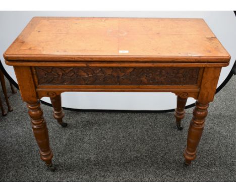 A late Victorian pollard oak card table, hinged quarter-veneered top enclosing a baize lined playing surface and counter well