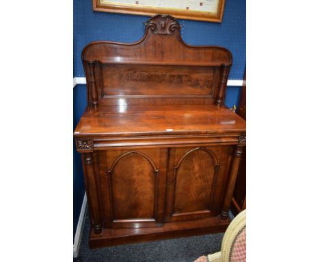 A Victorian mahogany chiffonier, substantial gallery crested by a vacant shield cartouche above a shelf, the base with a sing