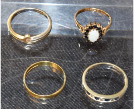 An 18ct yellow gold wedding band, 1.7g; a 9ct gold opal and sapphire dress ring, 1.9g; two other 9ct gold dress rings, 4.9g (