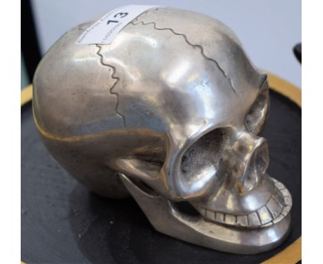 Macabre - a silver coloured metal desk model, skull, hinged jaw, 10cm high