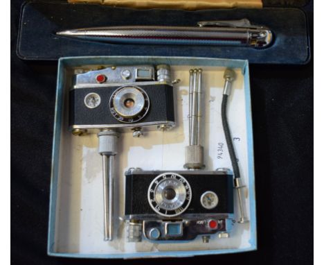 A novelty Phoenix cigarette lighter as a camera on tripod, compass to front; another similar; a Ronson Penciliter, boxed (3)
