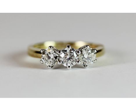 18ct yellow gold ring set with three brilliant cut diamonds. (K.5)