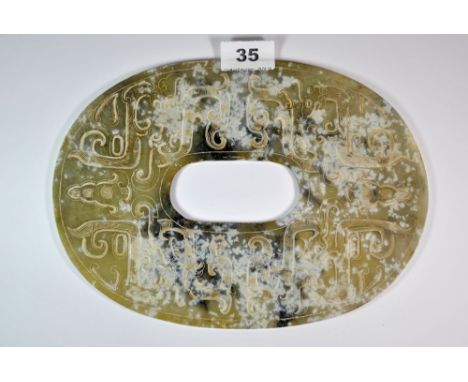 A Chinese archaic form carved jade disc, W. 26.5cm.