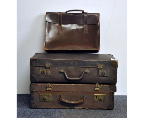 Two vintage suitcases and a leather music case.