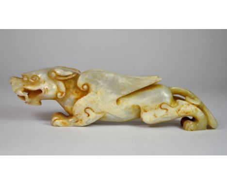 A Chinese carved jade figure of a winged dragon, probably 19th century or earlier, L. 16cm.