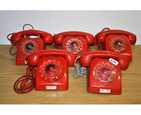 6 vintage red telephones.