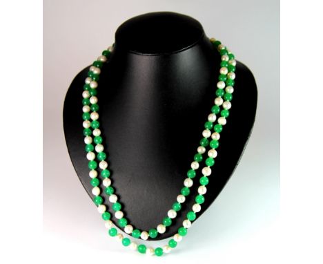 A single strand necklace of jade and cultured pearls, L. 118cm.