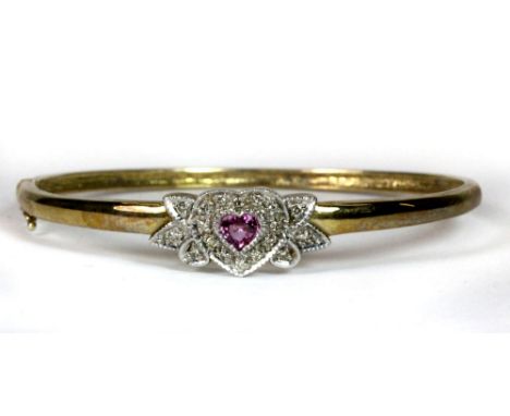 A 9ct gold bangle set with a heart shaped pink sapphire and diamonds.