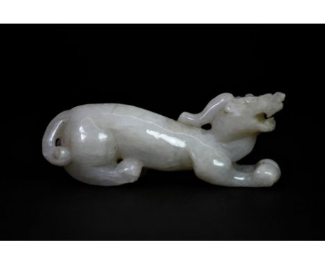A 19th century Chinese carved mutton fat jade figure of a dragon, L. 9cm.