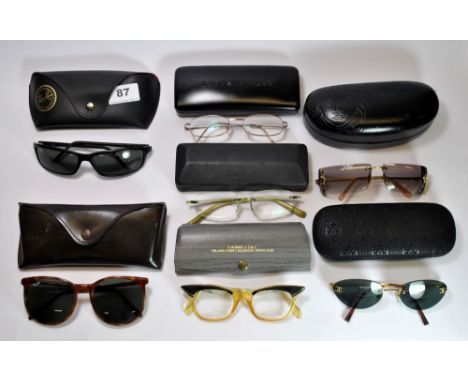 A quantity of vintage sunglasses and spectacles including Ray-Ban, Versace, Paul Smith and Karen Millen.