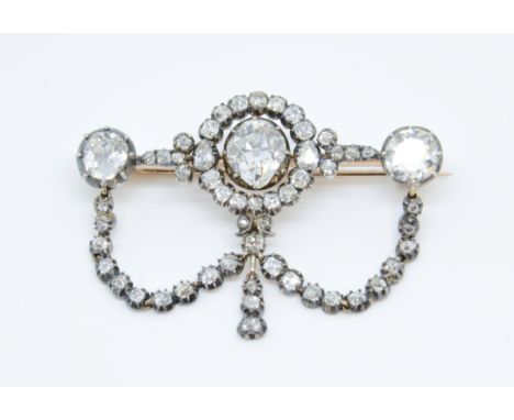 A fine antique diamond trefoil bar brooch, the centre cluster formation with a centre oval cushion shape old cut diamond flan