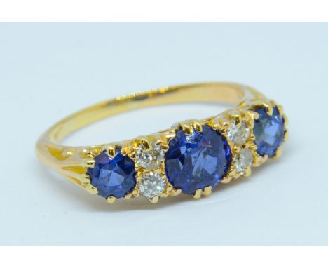 A sapphire and diamond ring set in yellow gold, unmarked, size K.