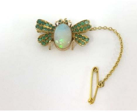 A opal and emerald bug brooch.