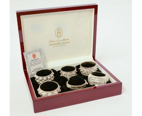 A cased set of six Oman sterling silver bangle design napkin rings, stamped 'OMAN 925'.