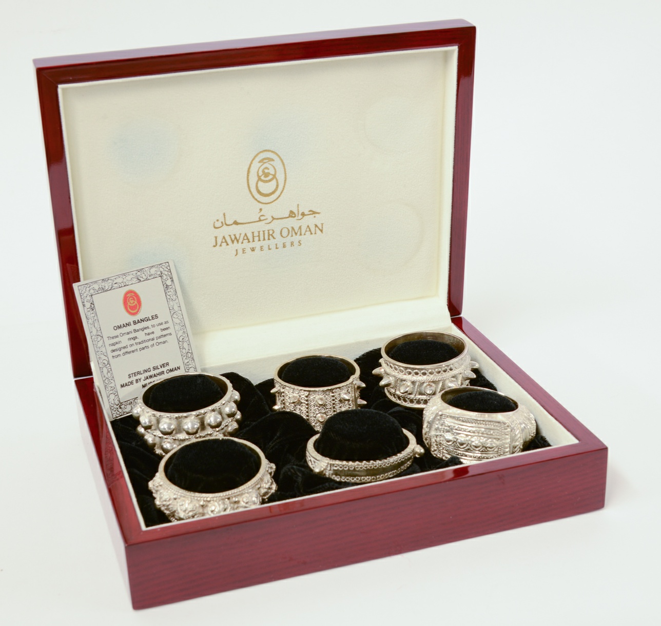A cased set of six Oman sterling silver bangle design napkin rings