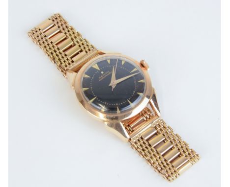 Zenith, a gents 18ct gold automatic wristwatch, marked '18k', with black dial and gilt batons, approx 58.50gms.