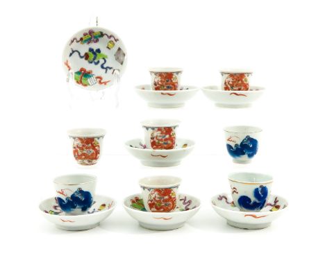 Decorated with Chinese antiquities, temple lions and dragons, saucers are 8 cm. in diameter. 