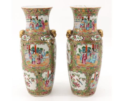 Depicting Chinese figures, birds, and butterflies, temple lion handles, 34 cm. tall, one vase restored.