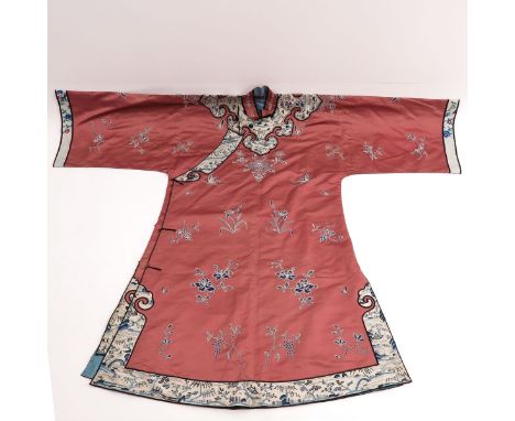 Pink silk decorated with embroidered butterflies and textiles of landscapes and pagodas.