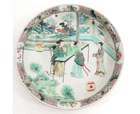 Depicting Chinese figures in garden with mountain landscape in background, 42 cm. in diameter, Kangxi mark.