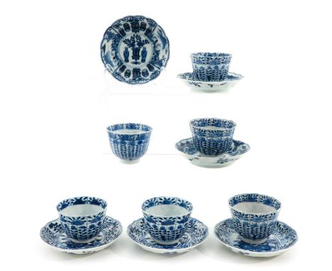 Blue and white floral decor, including Kangxi mark, saucers are 12 cm. in diameter, chip and hairline.