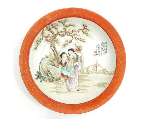 Depicting two Chinese ladies in garden holding fan and flowers with Chinese text and seal marks, 40 cm. in diameter. 