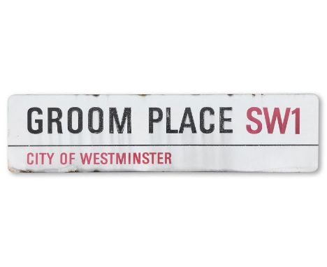 An enamelled iron street sign for Groom Place SW1, City of Westminster, with iconic and black and red sans serif lettering fi